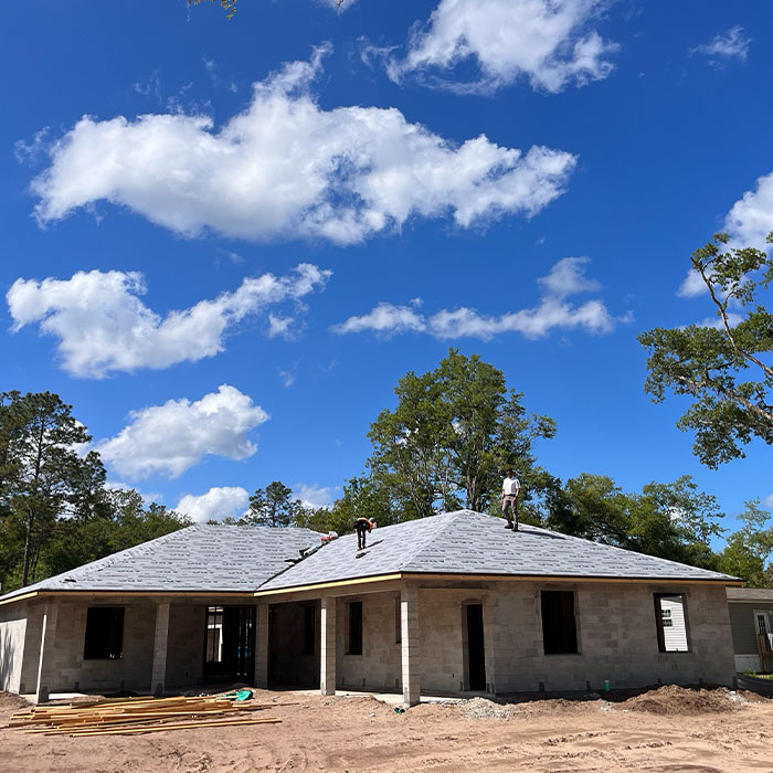 Workers on roof of new home construction