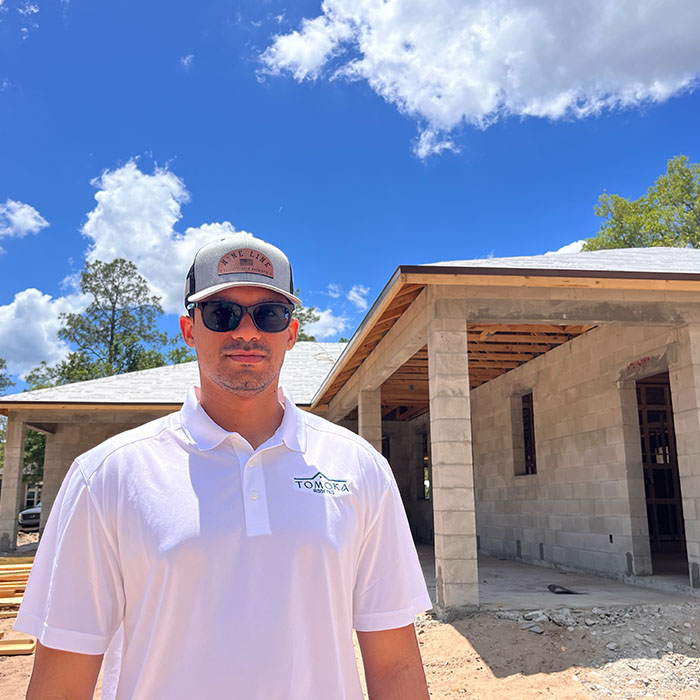 Worker in front of new home construction